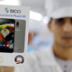 A factory worker holds up a package of Sico mobile phone in Assuit, Egypt September 30, 2018. Picture taken September 30, 2018.